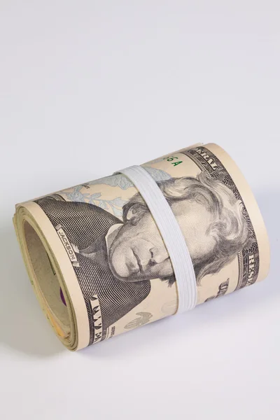 The roll of dollar bills with plastic band over the eyes — Stock Photo, Image