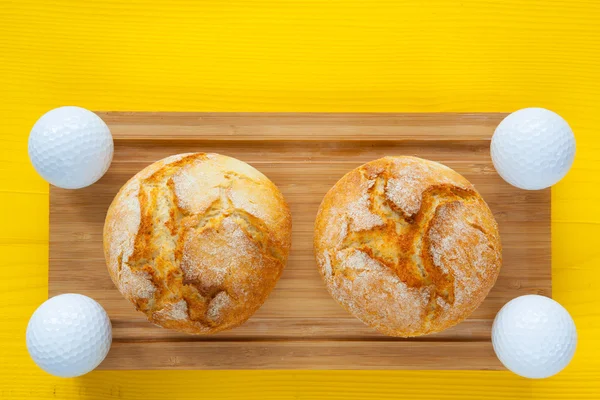 Golf breakfast - Two wheat bread and golf balls — Stock Photo, Image