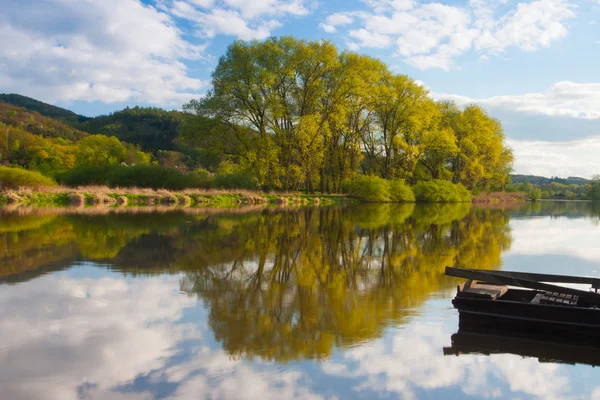 Wooden fishing punt on the river — Stock Photo, Image