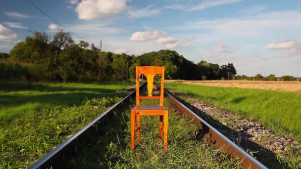 Railroad tracks and old wooden chair — Stock Video