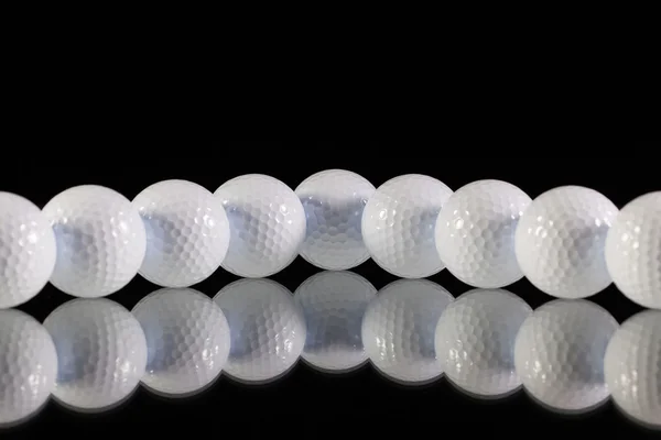 Golfballen op het Bureau van zwart glas — Stockfoto