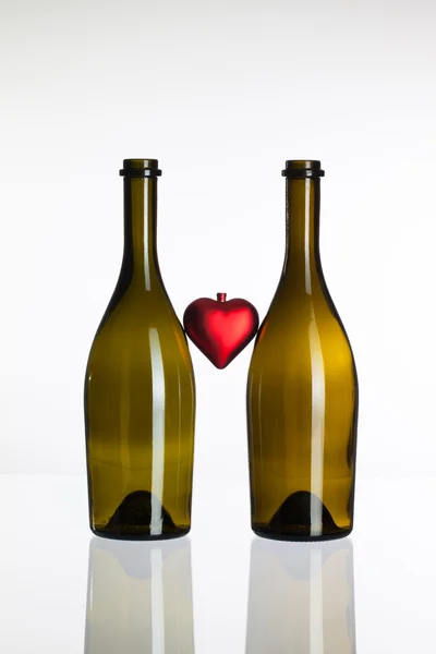 Prázdné lahve vína a lásku symbolu — Stock fotografie