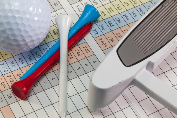 Equipos de golf acostados en una tarjeta de puntuación de golf —  Fotos de Stock