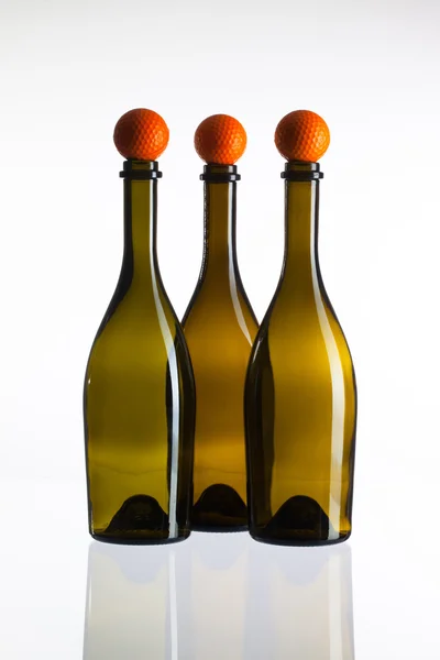 Empty three  wine bottles and golf balls — Stock Photo, Image