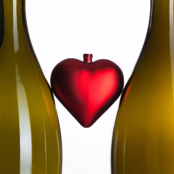 Empty bottles of wine and romantic symbol — Stock Photo, Image