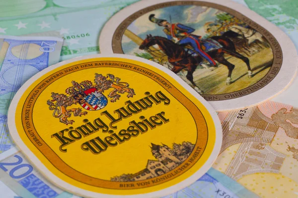 Beermats from Konig Ludwig beer and eur banknotes.. — Stock Photo, Image