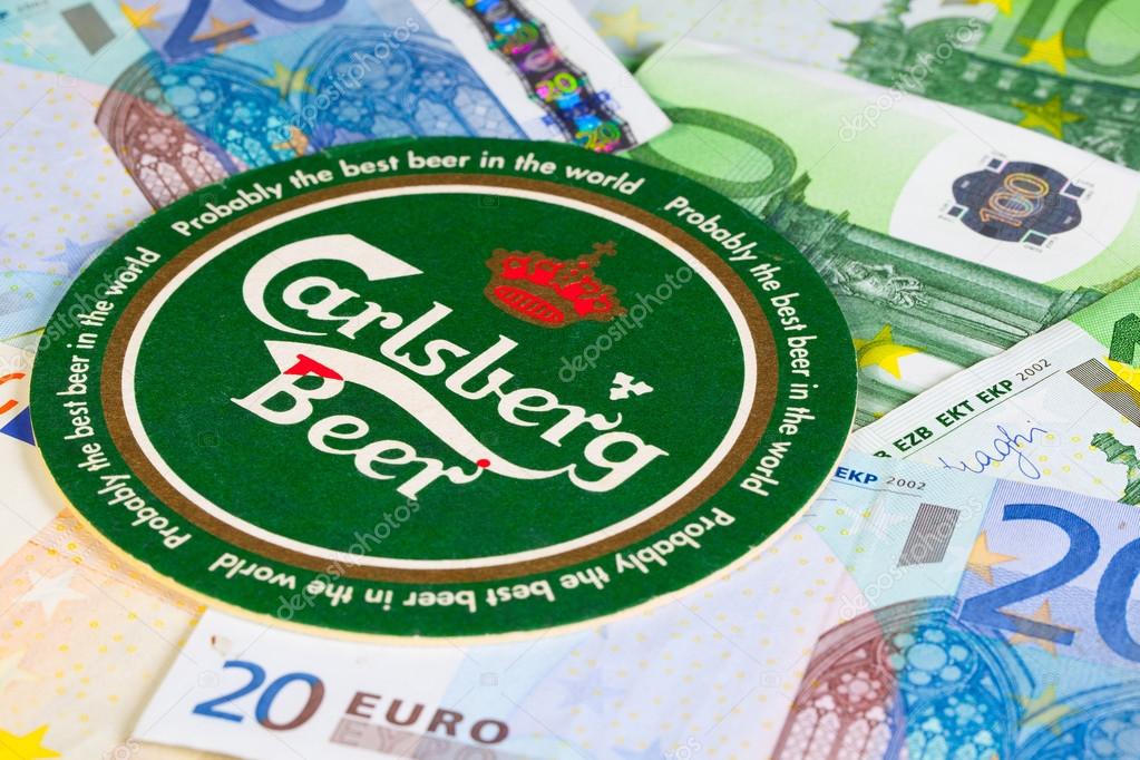 England, London - November 11, 2014:Beermat from Carlsberg beer and eur money.The Carlsberg is a Danish brewing company founded in 1847 by J. C. Jacobsen with headquarters located in Copenhagen,Denmark