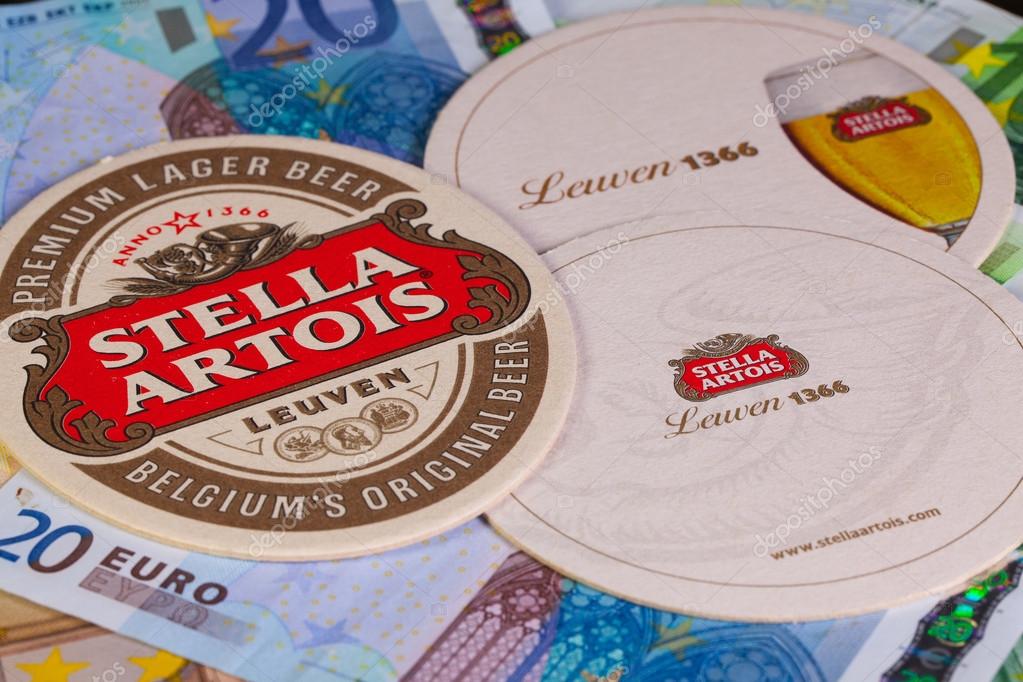 ENGLAND,LONDON - November 11, 2014:Beermats from Stella Artois and eur banknotes.It has been brewed in Leuven, Belgium, since 1926.Stella Artois is one of the prominent brands of Anheuser-Busch InBev