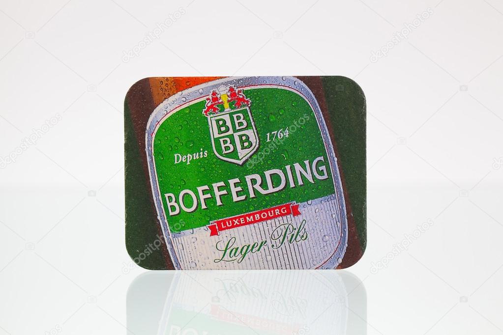 Germany,Berlin - January 7,2015:Beermat from Bofferding beer on a glass table.Brasserie Nationale is the largest brewery in Luxembourg, based in Bascharage.