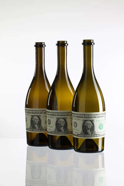 Empty bottles of wine from the label of dollar bill — Stock Photo, Image