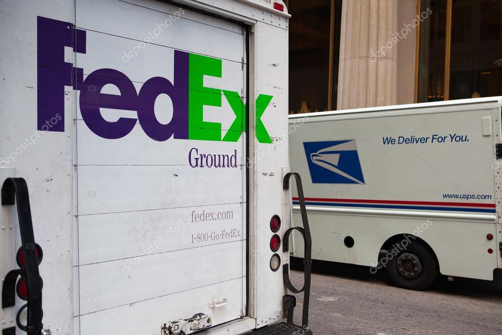 FedEx and USPS cars on the same street in New York. Stock Editorial