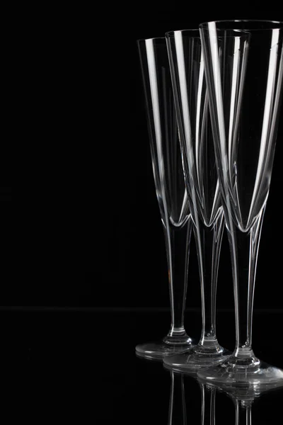 Three champagne glasses on a glass plate — Stock Photo, Image