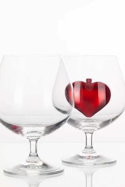 Red heart inside a glass of cognac — Stock Photo, Image