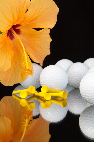 Orange hibiscus flower  and golf equipments on the glass table — Stock Photo, Image