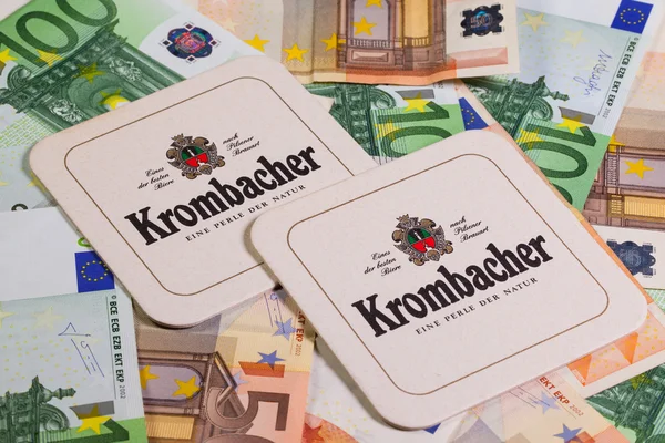 Beermats from Krombacher beer and eur money. — Stock Photo, Image