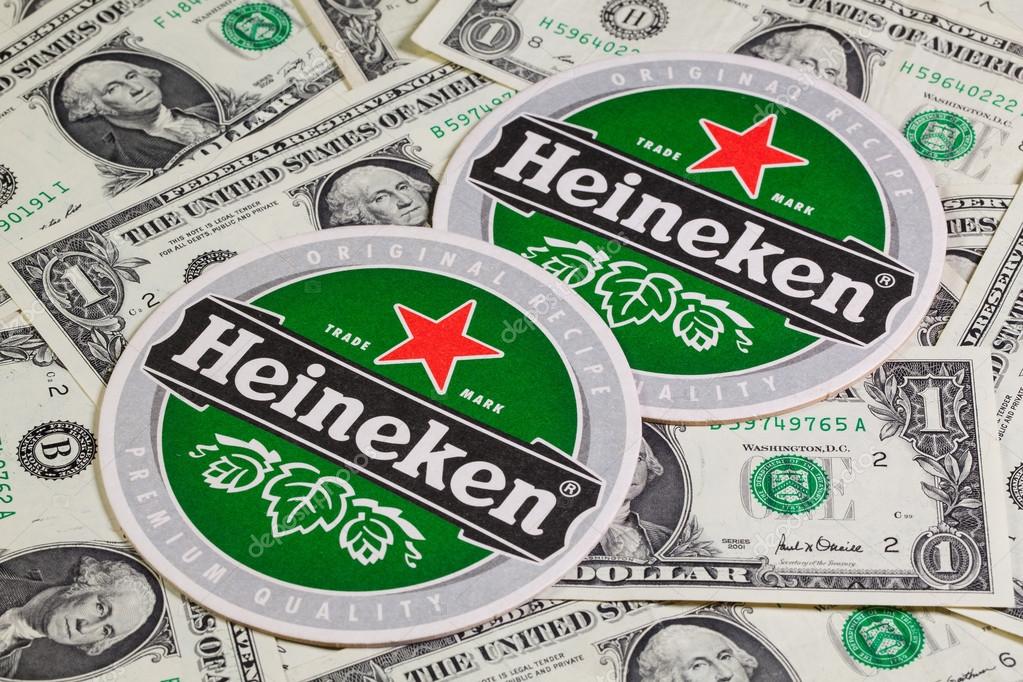 Czech Republic, Brno - January 5,2015: Beermat from Heineken beer and US dollars.Heineken Lager Beer,it was first brewed by Gerard Adriaan Heineken in 1873