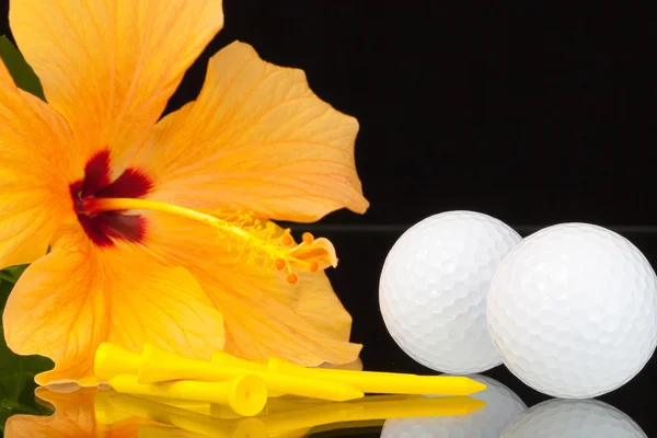 Orange hibiscus flower  and golf equipments on the glass table — Stock Photo, Image