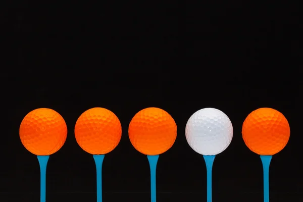 Golf balls on blue wooden tees — Stock Photo, Image