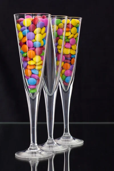 Color chocolate tablets inside the champagne glasses — Stock Photo, Image