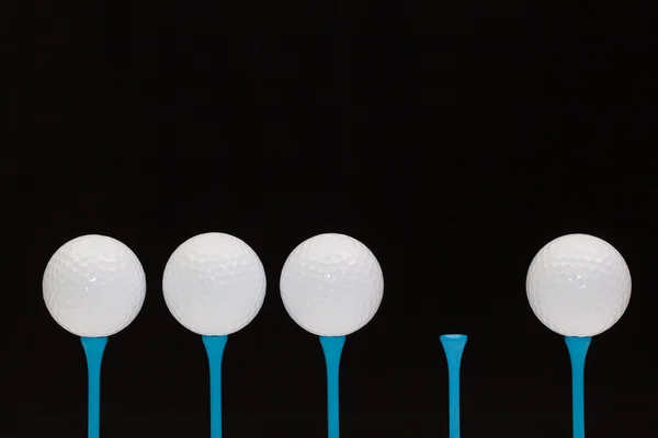 Golf balls on blue wooden tees — Stock Photo, Image