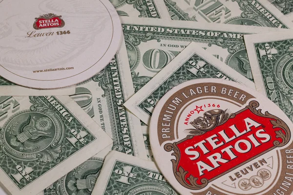 Beermats from Stella Artois and US dollars. — Stock Photo, Image