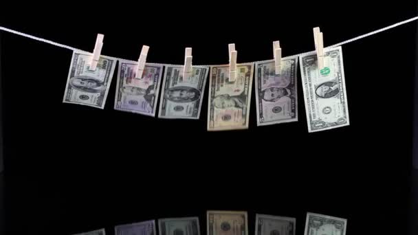 Dirty US dollar banknotes hanging from a clothesline and reflecting in the glass — Stock Video