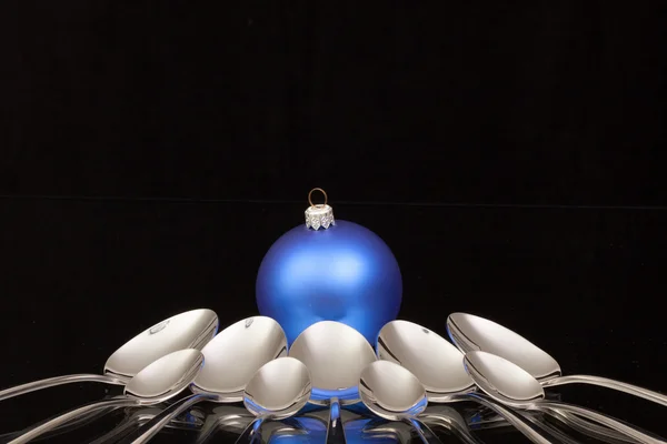 Blue Christmas decoration and nine spoons — Stock Photo, Image