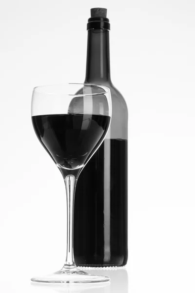 Wine glass and bottle with red wine — Stock Photo, Image