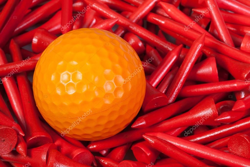 Orange golf ball lying between wooden tees — Stock Photo © CaptureLight 86539006