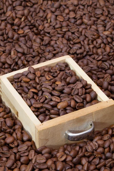Grains de café sur la table en bois — Photo