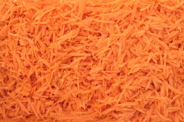 Struttura piena di carote grattugiate. Contesto alimentare. — Foto Stock