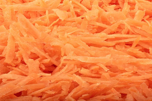 Struttura piena di un mucchio di carote grattugiate. Contesto alimentare. — Foto Stock