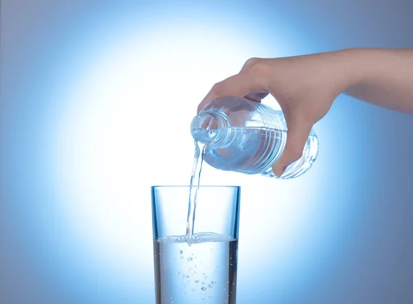 Plastic bottle with mineral water in a female hand. — Stock Photo, Image