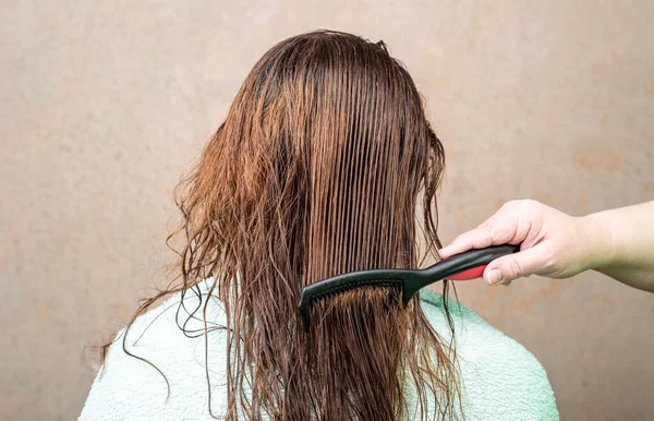 Strips of wet female hair after combing. Hair care.