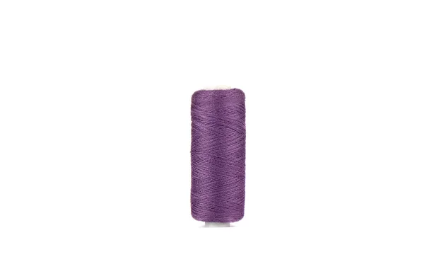 Fadenspule in lila Farbe isoliert auf weißem Hintergrund. — Stockfoto
