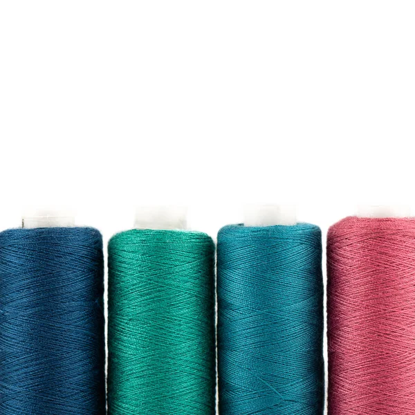 Close-up of spools of colored thread on a white background. — Stock Photo, Image