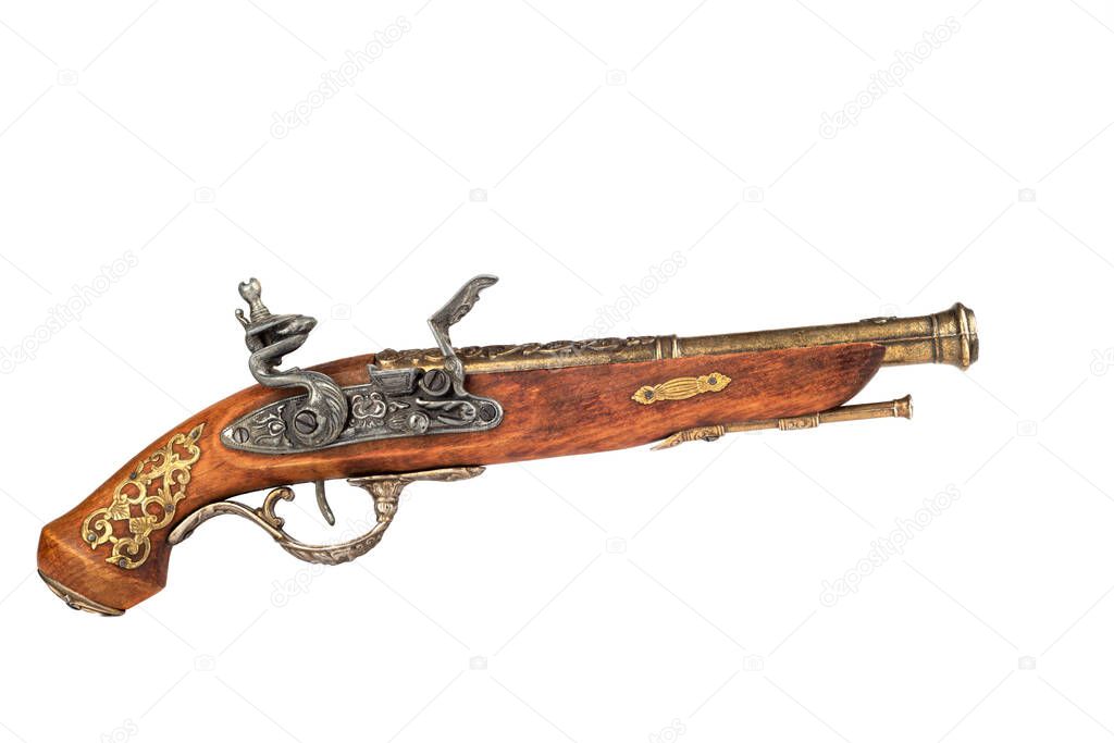 A model of an old pistol with a cocked trigger. Pistol ready to fire isolated on white background.