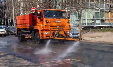 March 28, 2020, Moscow, Russia. Municipal equipment performs sanitary treatment of the street. clipart