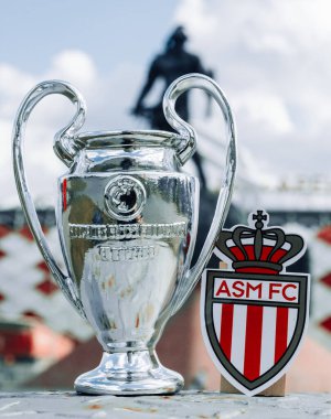 14 Haziran 2021 Monako, AS Monaco FC amblemi ve UEFA Şampiyonlar Ligi Kupası modern bir stadyumun önünde..