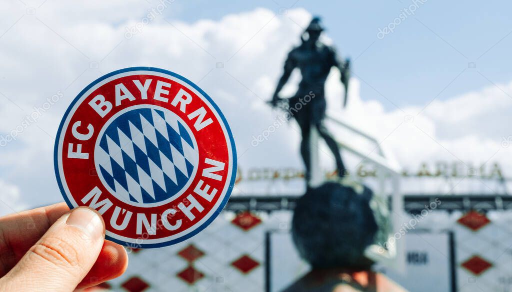 June 14, 2021 Munich, Germany. The emblem of the football club FC Bayern Munich against the background of a modern stadium.