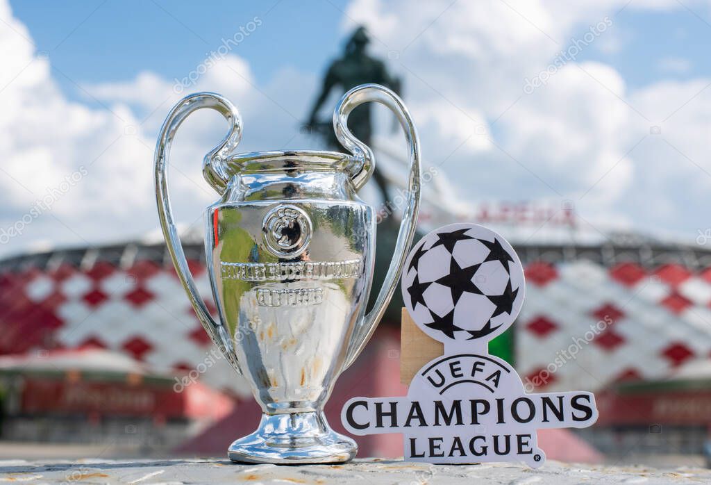 June 14, 2021 Moscow, Russia, UEFA Champions League Cup and emblem in front of a modern stadium.