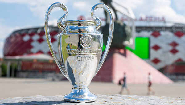 June 14, 2021 Moscow, Russia, UEFA Champions League Cup in front of a modern stadium.