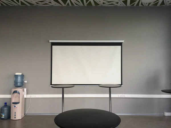 White slide projector screen in the modern building interior