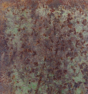 Yeşil boya izleriyle paslı metal doku.