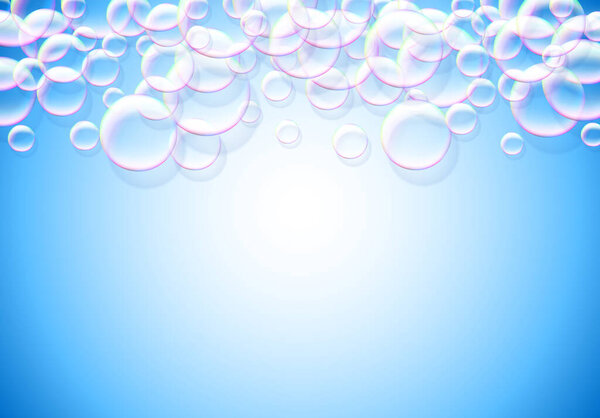 Soap bubbles blue background with rainbow colored airy foam