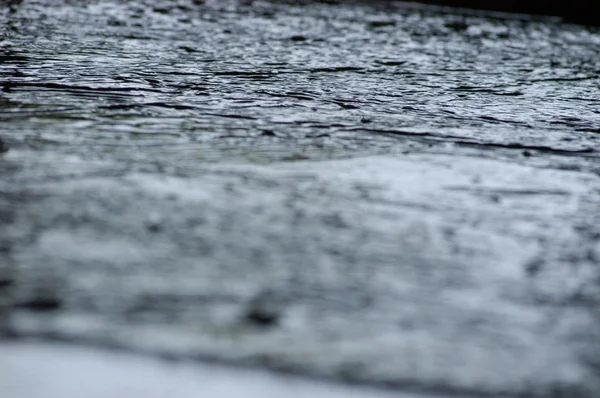 Wet asphalt road after the rain. Asphalt background. Asphalt