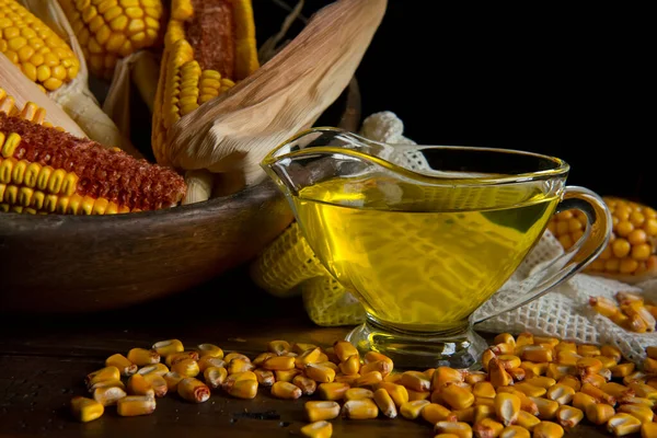 cobs and corn oil on old wooden table