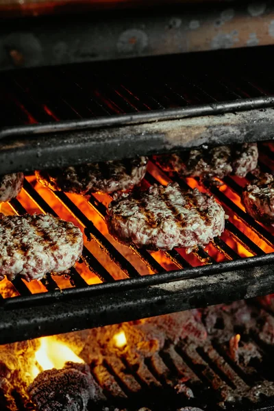 Burger szeletek egy grill - szeletek készült organikus marhahús. nyers szeletek. közelről — Stock Fotó