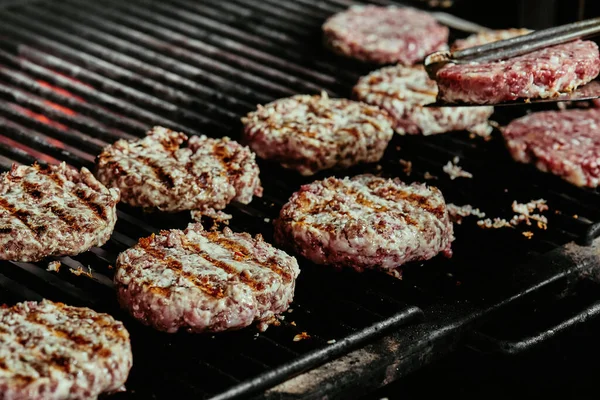Hamburgerkoteletten op een grill - koteletten gemaakt van biologisch rundvlees. rauwe koteletten. close-up — Stockfoto