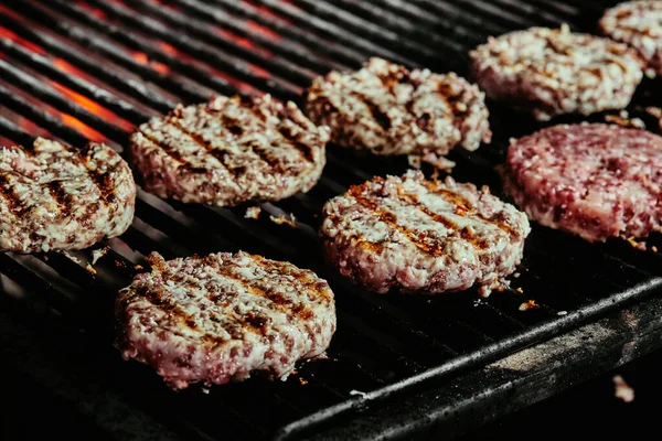 Burger cutlets on a grill - cutlets made from organic beef. raw cutlets. close up — Stock Photo, Image